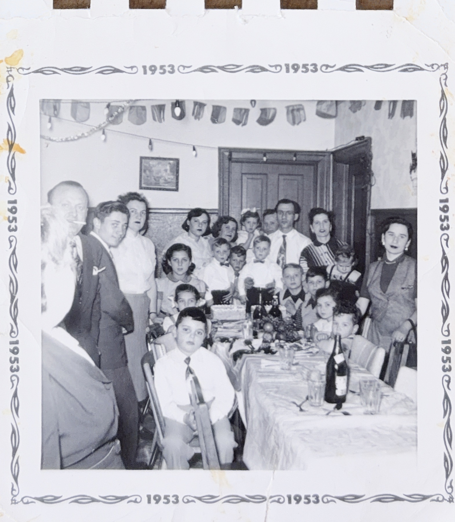 Morris seated at the front of a crowded family banquet
