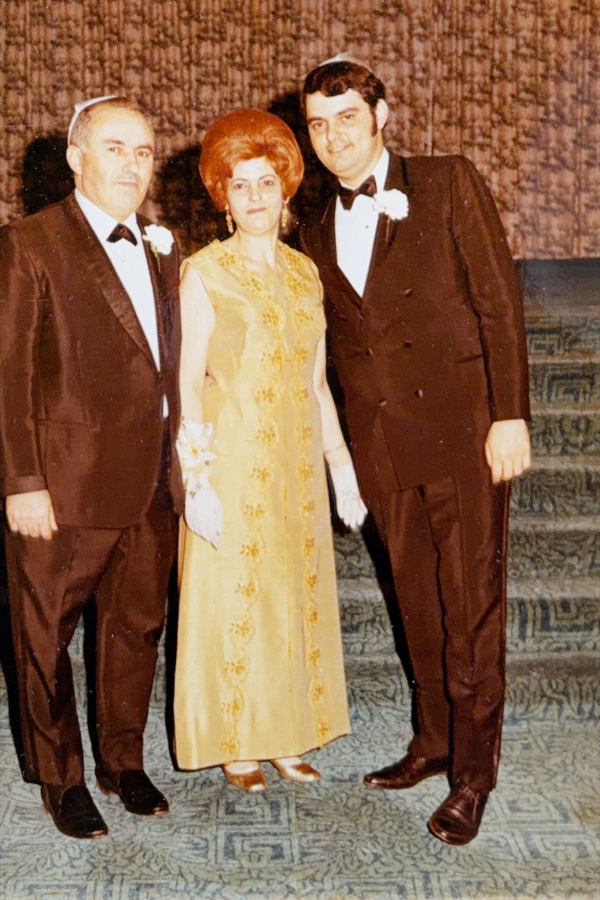 A young Morris in formalwear standing with his parents