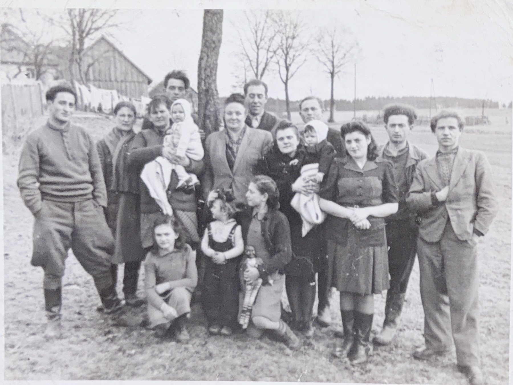 A large family and community group gathered outdoors